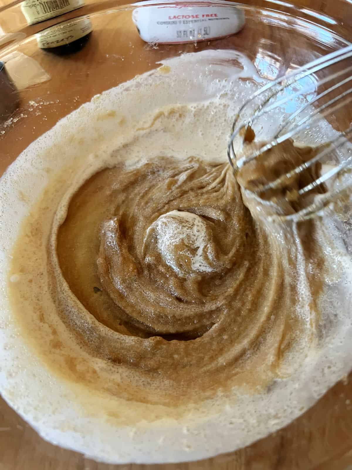 Whisking the first bit of heavy cream into the bowl.