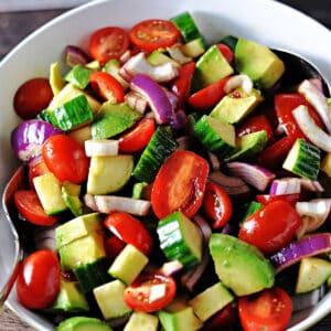 close up of balsamic cucumber and tomato salad with avocado.