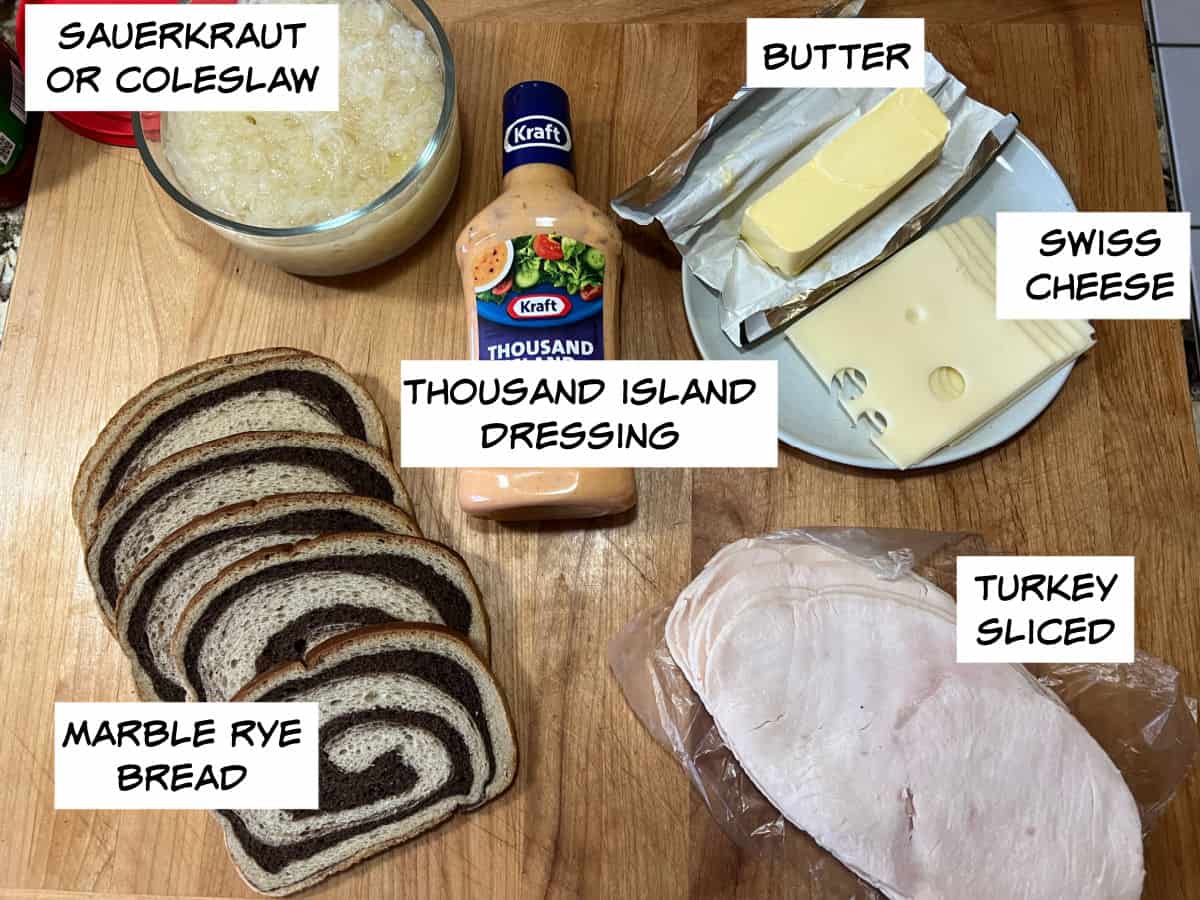 Ingredients: sauerkraut or coleslaw, butter, Swiss cheese, turkey, marble rye bread, and thousand island dressing.