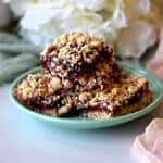 A small plate of raspberry oatmeal bars (raspberry oat squares).