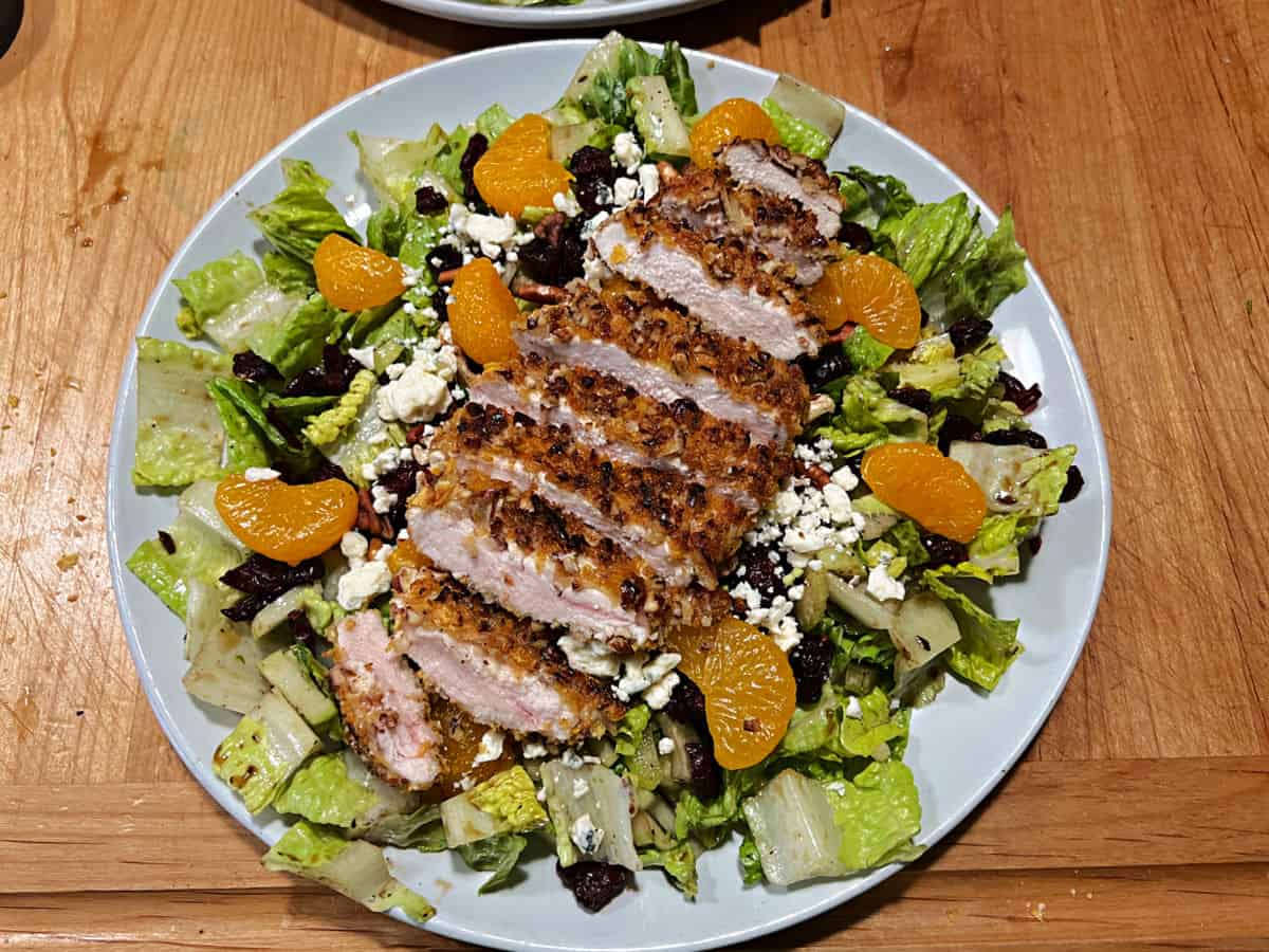 Assembled salad with pecan crusted chicken.