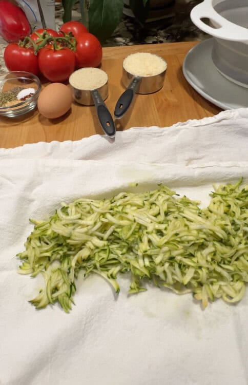 Shredded zucchini on a kitchen towel