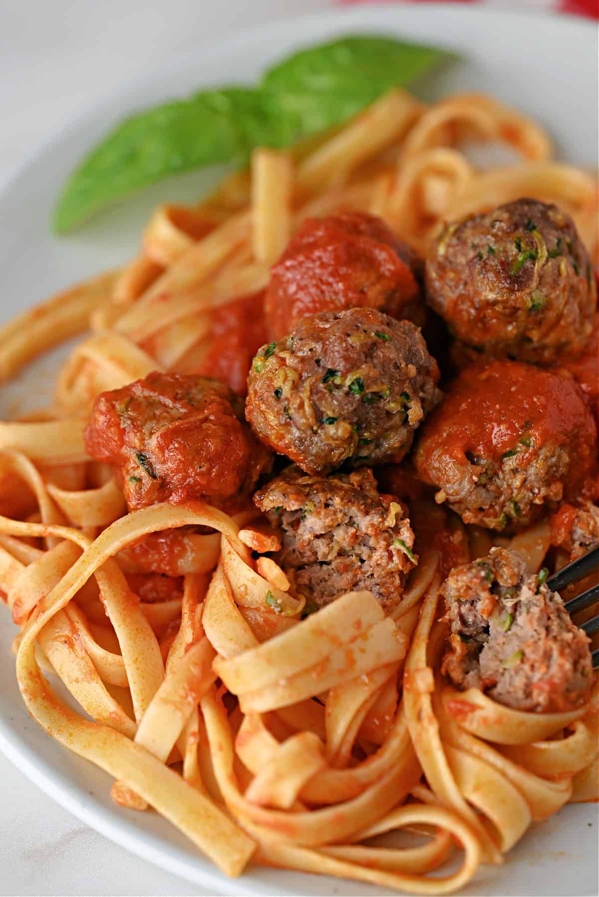 zucchini meatballs and sauce on noodles.