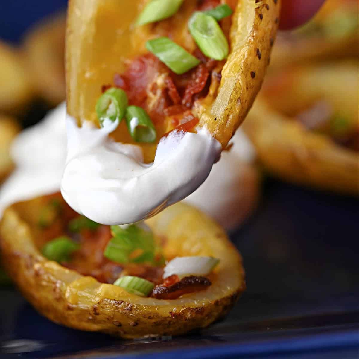 Loaded potato skin made int eh air fryer and dipped in sour cream.