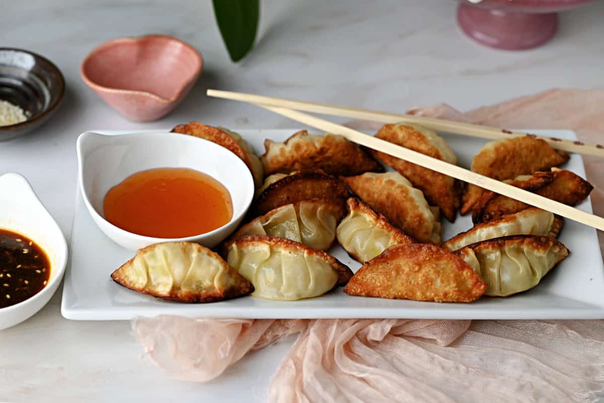 potstickers (Chinese dumplings) served with dipping sauce.