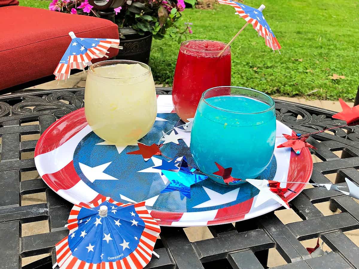 Red White Blue Vodka slush on a table outdoors.
