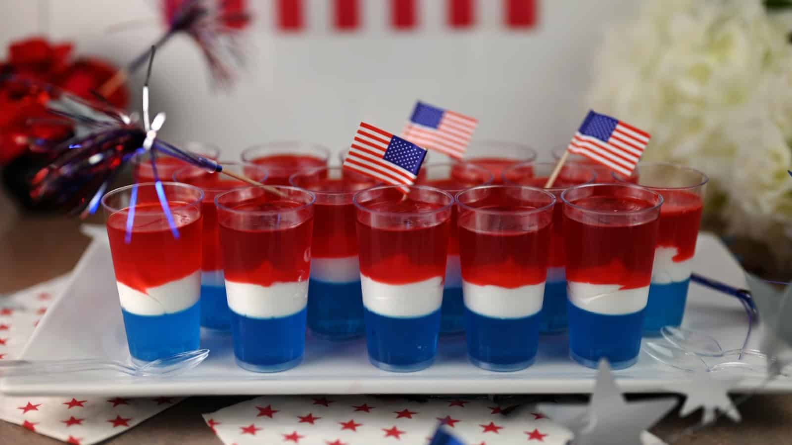 red white and blue jello shots ready to serve.
