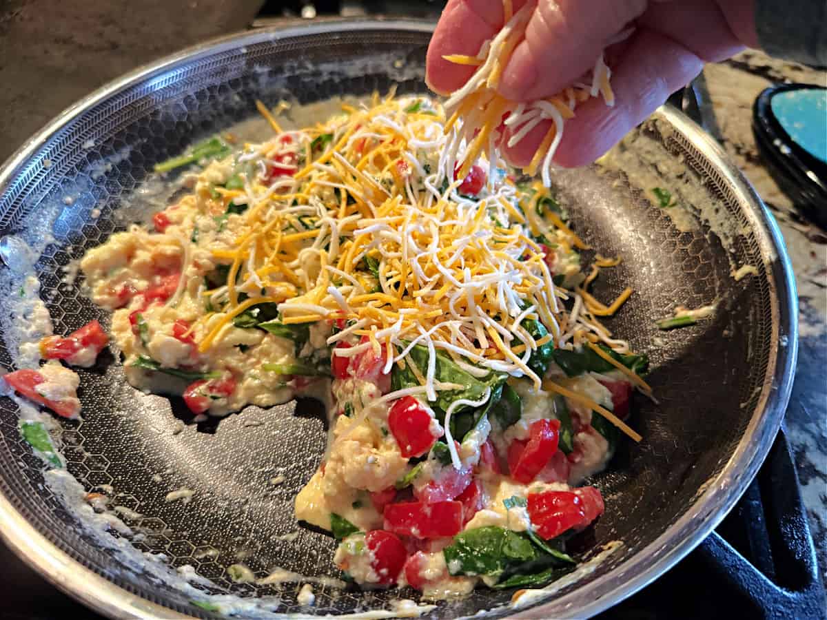 adding a final sprinkle of cheese.