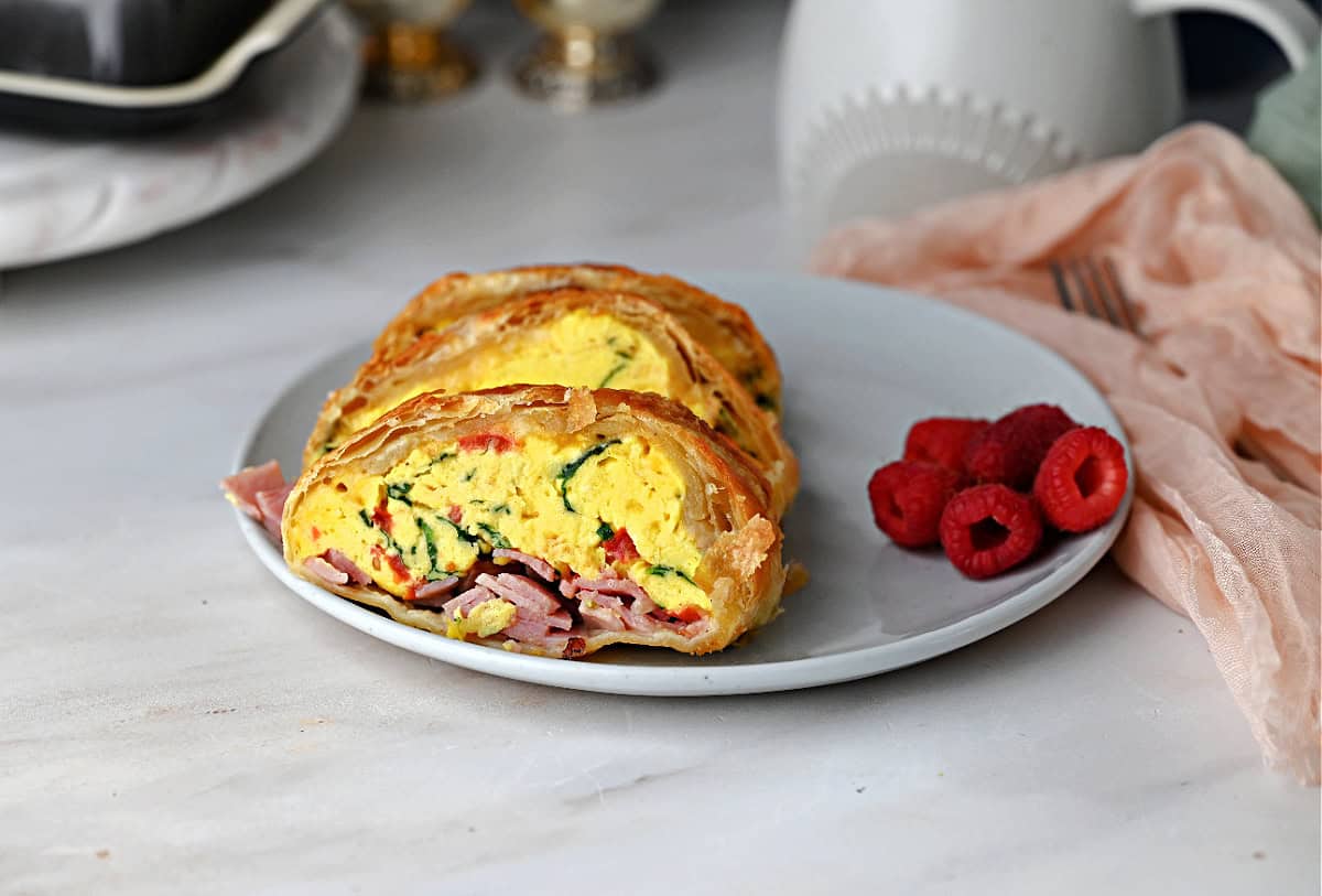 Slices of scrambled eggs wrapped in puff pastry, ready to eat.