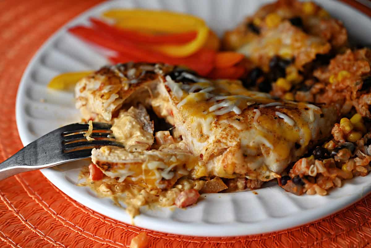Cutting into the Fajita stuffed chicken to show the creamy filling.