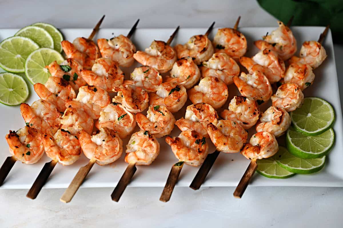 a platter of margarita shrimp skewers ready to eat.