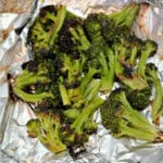 grilled broccoli in a foil packet, ready to eat.