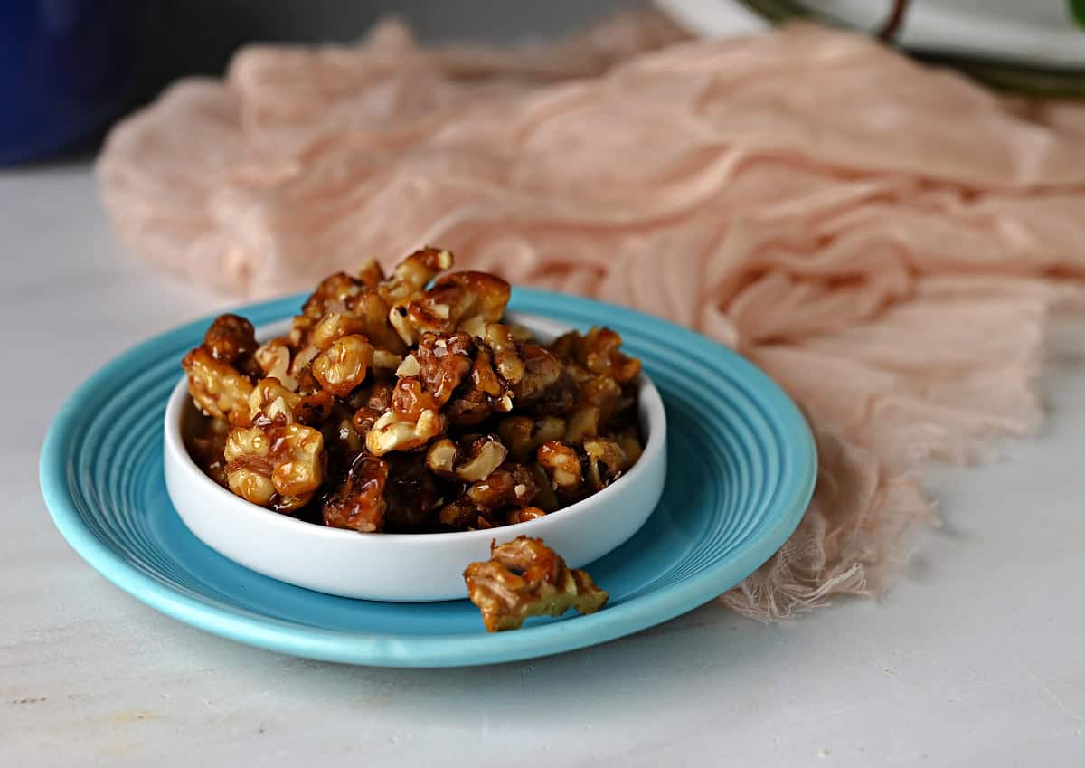 A dish of glossy candied walnuts ready to use or eat!