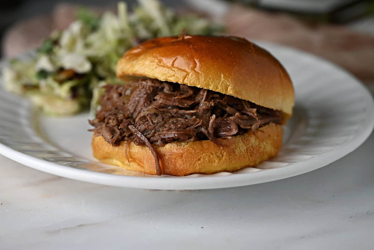 a sandwish filled with juicy shredded beef made in the Crockpot and ready to eat.