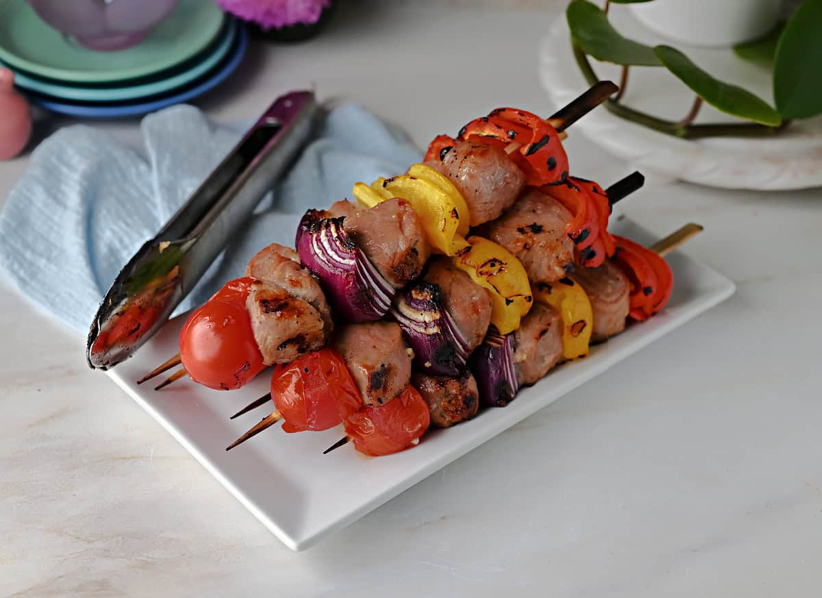 a platter of grilled pork skewers ready to serve.