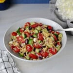 Greek orzo salad in a serving bowl, ready to eat.