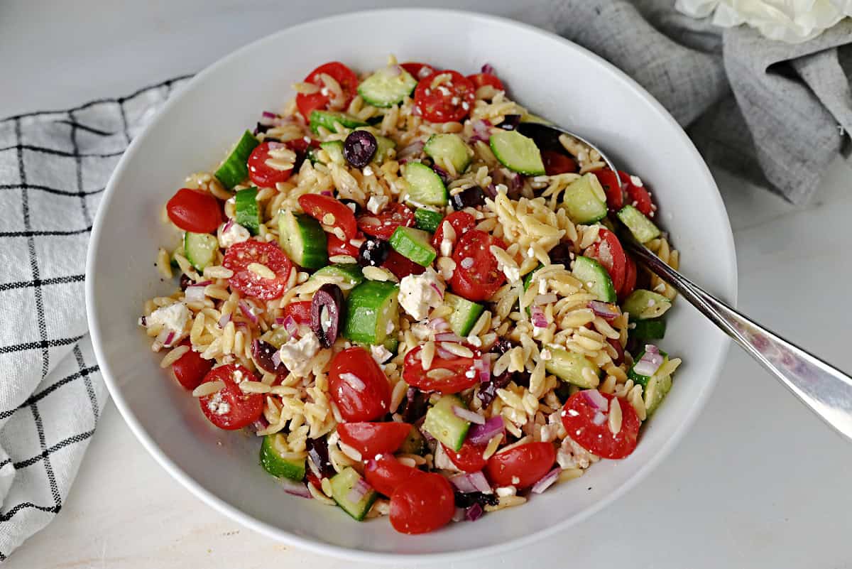 a serving bowl of Mediterranean orzo pasta salad.
