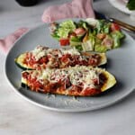 2 halves of stuffed zucchini, served with salad and ready to eat!