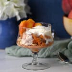 a serving of easy peach crisp with a scoop of vanilla ice cream.