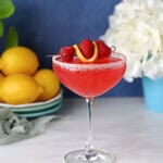 a coupe glass filled with a raspberry lemon drop martini.
