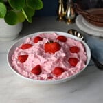 a serving bowl of strawberry fluff salad with cottage cheese.
