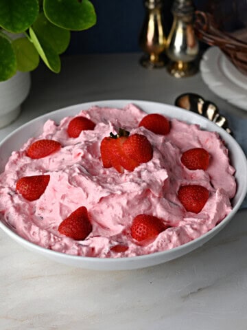 a serving bowl of strawberry fluff salad with cottage cheese.