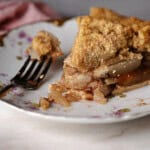 a slice of apple pie made with canned pie filling on a plate with a fork.