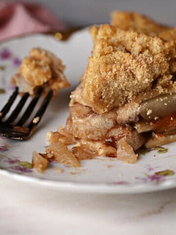 a slice of apple pie made with canned pie filling on a plate with a fork.