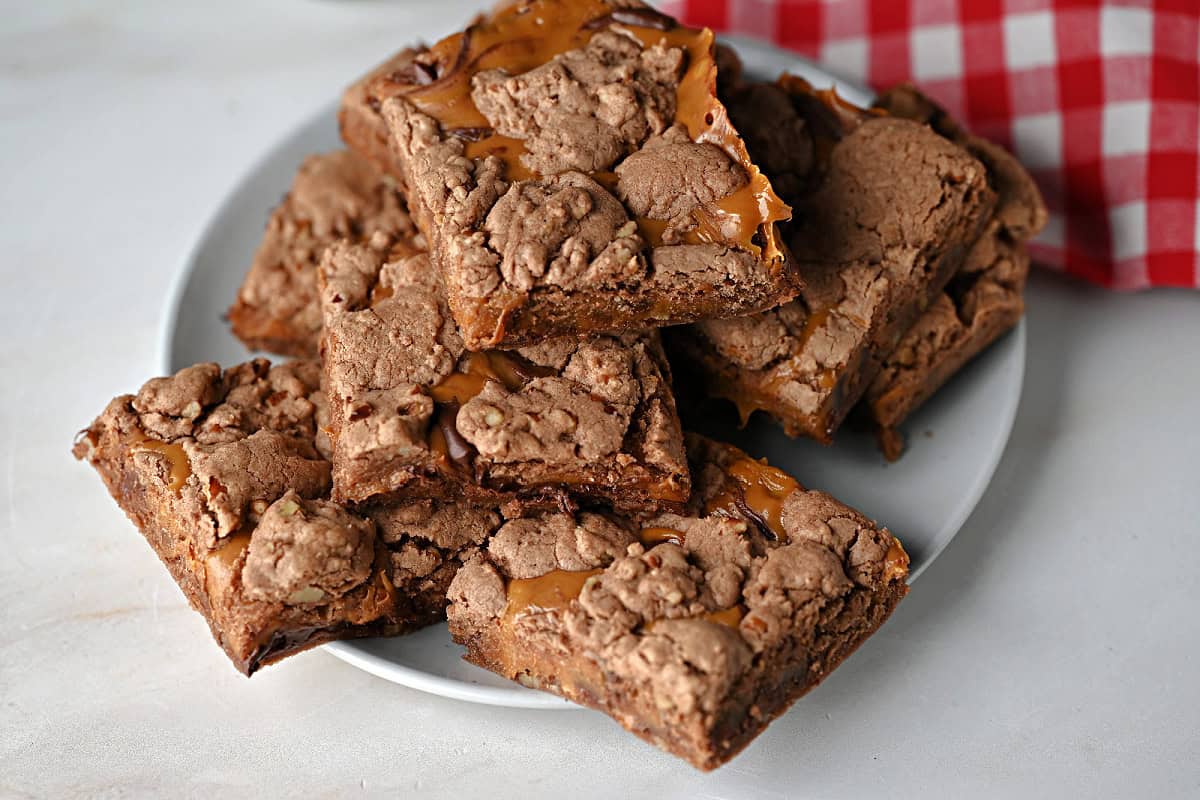 a plate of caramel stuffed brownies ready to eat.