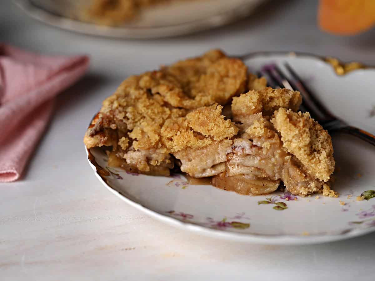 a slice of homemade apple pie ready to eat.