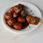 a small plate of cranberry meatballs made with BBQ sauce and cranberry sauce.