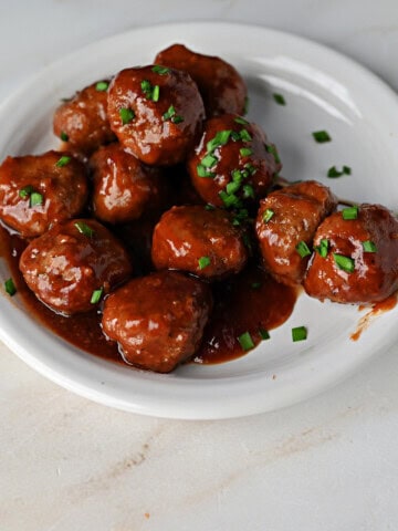 a small plate of cranberry meatballs made with BBQ sauce and cranberry sauce.