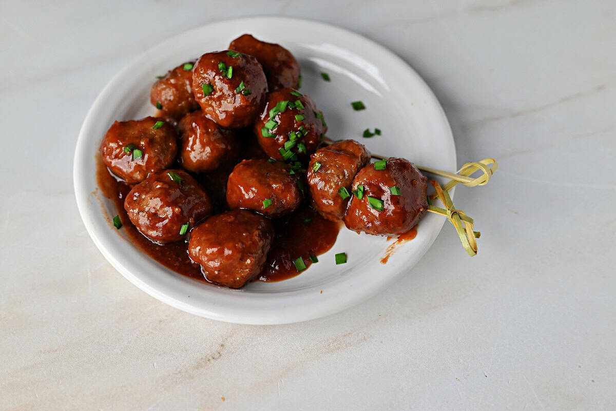 a small plate of cranberry meatballs made with BBQ sauce and cranberry sauce.