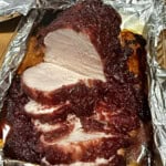 sliced cranberry glazed turkey ready to serve.
