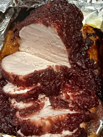 sliced cranberry glazed turkey ready to serve.